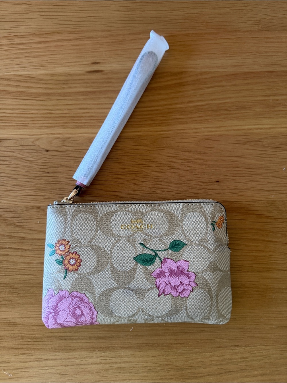 COACH Beige Signature Floral Wristlet with Pink & Green Accents